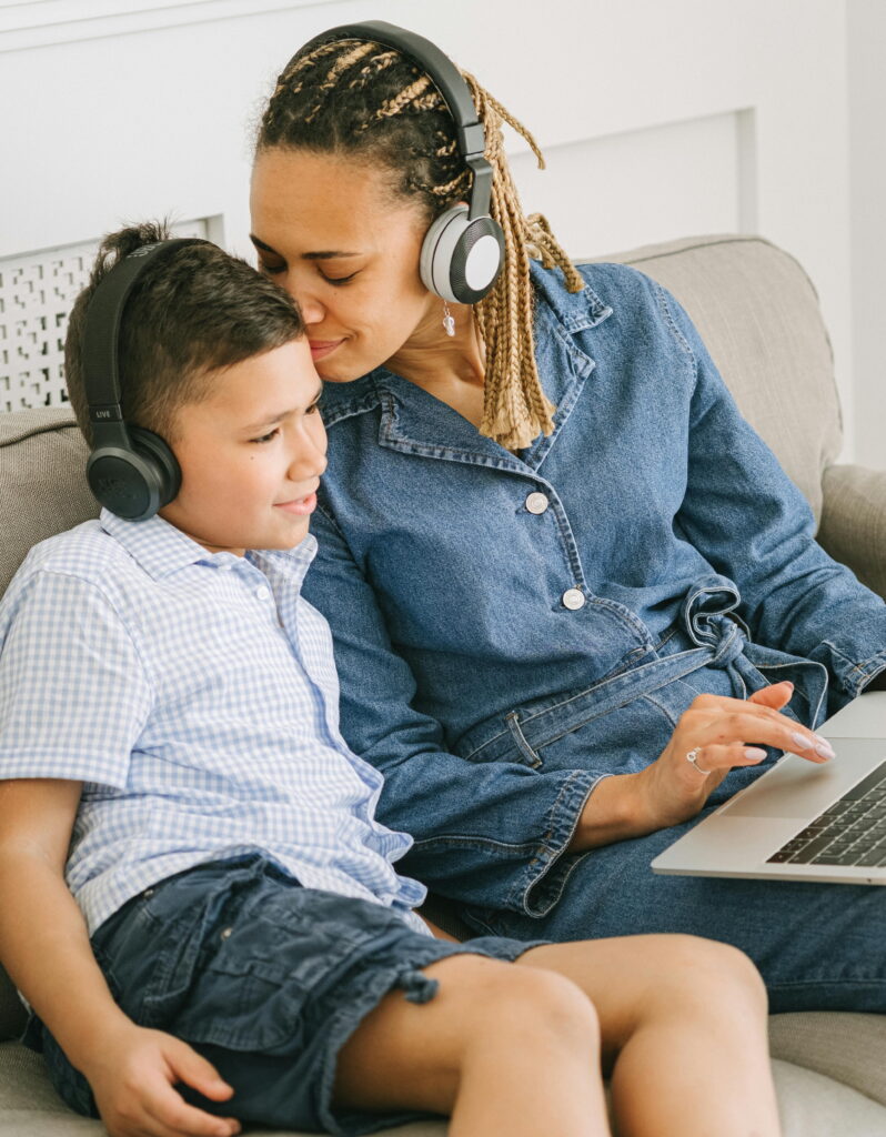 A mother bonding with her neurodivergent child on headphones to minimise audio distractions.
