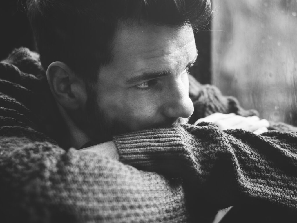 Unhappy man staring out the window; looking for help for depression; I am suffering; I need help; counsellors who help with depression;